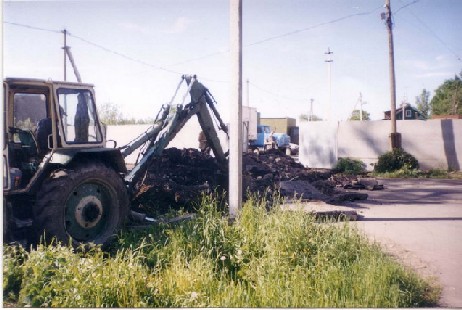 Excavator making trench in the center of Staraya Ladoga for new shop. June, 2004